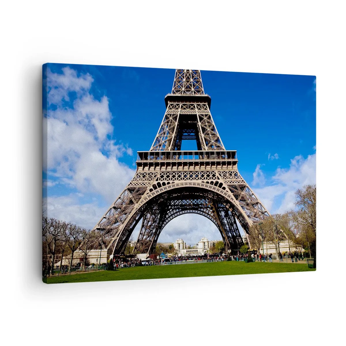 Obraz na plátně - Eiffelova věž na pozadí modré oblohy a zeleného parku - 70x50cm - Celá Paříž u jejích nohou - Moderní nástěnná dekorace do obývacího pokoje a ložnice ARTTOR