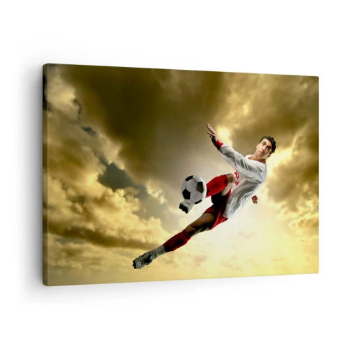 Obraz na plátně - Fotbalista v dynamickém skoku kope míč proti obloze - 70x50cm - Fotbalové nebe - Moderní nástěnná dekorace do obývacího pokoje a ložnice ARTTOR