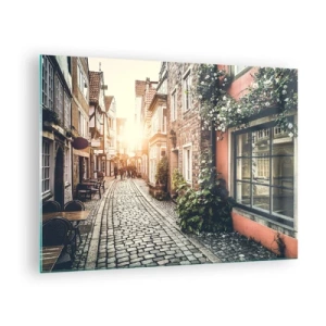 Obraz na skle - Okouzlující ulice s činžovními domy ozářenými západem slunce - 70x50cm - Růžová ulička v růžové září - Moderní nástěnná dekorace do obývacího pokoje a ložnice ARTTOR