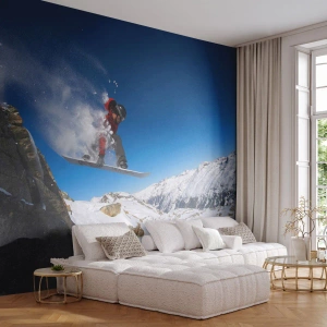 Fototapeta Standard Eco - Snowboardista skáče na pozadí zasněžených hor. - 100x70cm - A stal ses součástí prostoru - Moderní nástěnná dekorace do obývacího pokoje a ložnice ARTTOR
