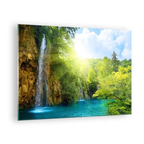 Obraz na skle - Vodopád vlévající se do modrého jezera obklopeného zelení - 70x50cm - To musí být Eden - Moderní nástěnná dekorace do obývacího pokoje a ložnice ARTTOR