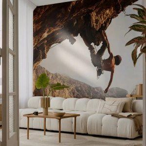 Fototapeta Standard Eco - Horolezectví na strmém útesu s impozantním výhledem - 100x70cm - Svět smrsknutý v ruce na sesuvu balvanu - Moderní nástěnná dekorace do obývacího pokoje a ložnice ARTTOR
